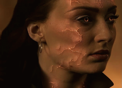 A Close Up Of A Woman 'S Face With Cracks GIF
