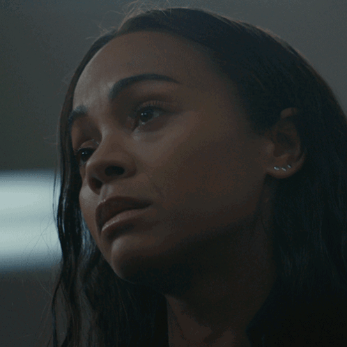 A Close Up Of A Woman 'S Face With Dark Hair GIF