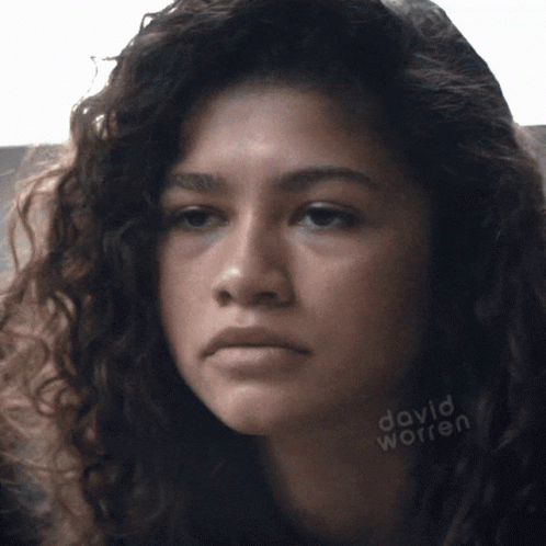 A Close Up Of A Woman 'S Face With David Worren Written On The Bottom Right GIF