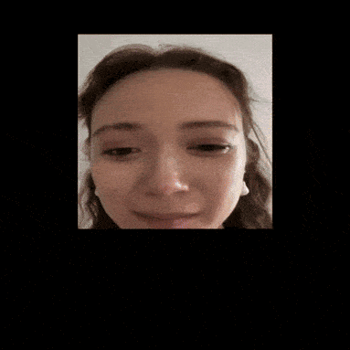 A Close Up Of A Woman 'S Face With Earrings GIF