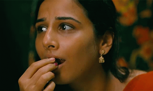 A Close Up Of A Woman 'S Face With Earrings On GIF