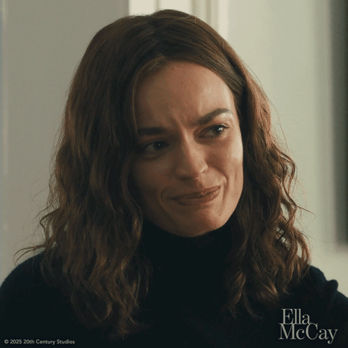 A Close Up Of A Woman 'S Face With Ella Mccay In The Corner GIF
