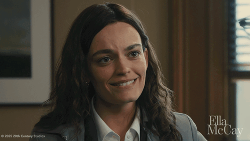 A Close Up Of A Woman 'S Face With Ella Mccay On The Bottom GIF