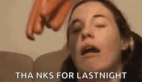 A Close Up Of A Woman 'S Face With Her Eyes Closed And A Hand Pointing At Her . GIF
