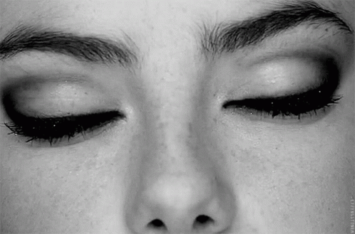 A Close Up Of A Woman 'S Face With Her Eyes Closed And Her Eyebrows Visible . GIF