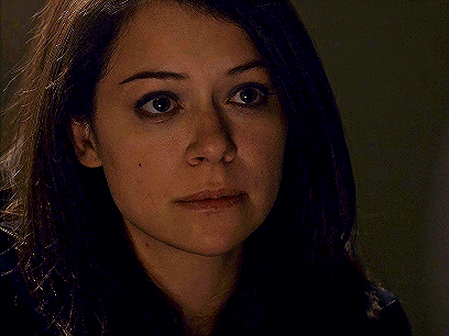 A Close Up Of A Woman 'S Face With Her Eyes Closed And Her Hair Blowing In The Wind . GIF