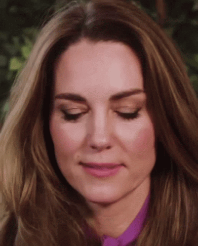 A Close Up Of A Woman 'S Face With Her Eyes Closed And Her Mouth Open . GIF