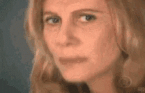 A Close Up Of A Woman 'S Face With Her Eyes Closed And Her Mouth Open . GIF
