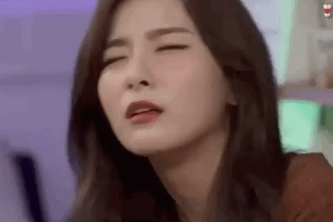 A Close Up Of A Woman 'S Face With Her Eyes Closed And Her Mouth Open . GIF