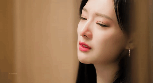 A Close Up Of A Woman 'S Face With Her Eyes Closed And Her Mouth Open . GIF