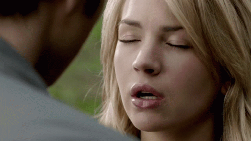 A Close Up Of A Woman 'S Face With Her Eyes Closed And Her Mouth Open GIF