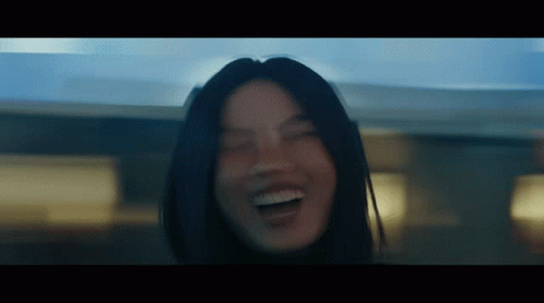 A Close Up Of A Woman 'S Face With Her Eyes Closed And Her Mouth Open GIF
