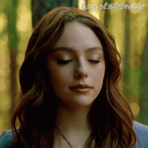 A Close Up Of A Woman 'S Face With Her Eyes Closed And The Words Hxpelzbonair Written On The Bottom GIF
