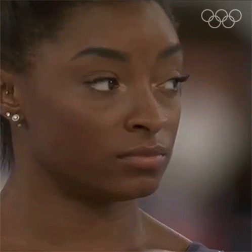 A Close Up Of A Woman 'S Face With Her Eyes Closed GIF