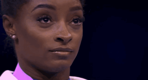 A Close Up Of A Woman 'S Face With Her Eyes Closed GIF