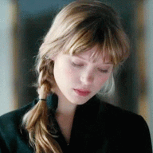 A Close Up Of A Woman 'S Face With Her Eyes Closed . GIF