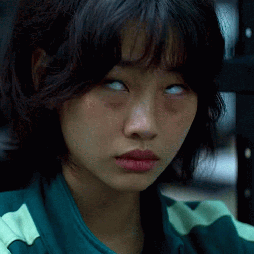 A Close Up Of A Woman 'S Face With Her Eyes Closed GIF