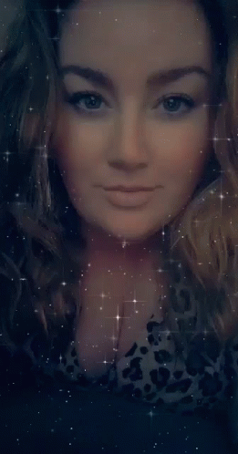 A Close Up Of A Woman 'S Face With Her Eyes Closed Surrounded By Stars GIF