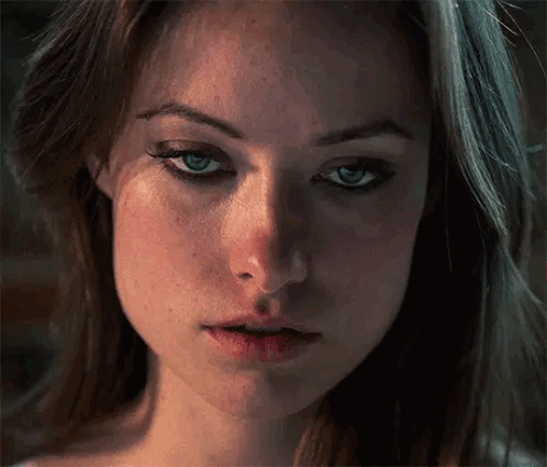 A Close Up Of A Woman 'S Face With Her Eyes Closed . GIF
