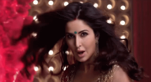 A Close Up Of A Woman 'S Face With Her Hair Flying In The Wind . GIF