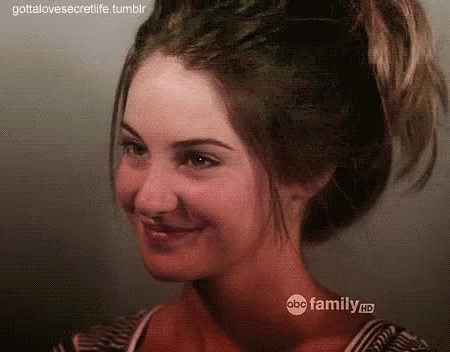 A Close Up Of A Woman 'S Face With Her Hair In A Ponytail . GIF