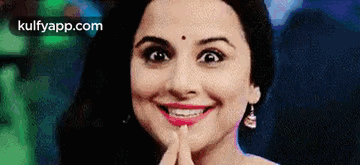 A Close Up Of A Woman 'S Face With Her Hand On Her Chin . GIF