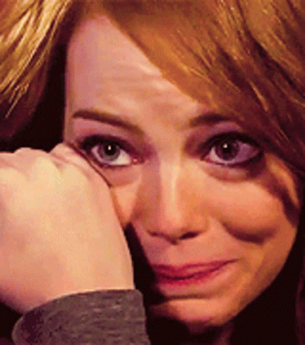 A Close Up Of A Woman 'S Face With Her Hand On Her Face GIF