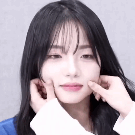 A Close Up Of A Woman 'S Face With Her Hands On Her Face . GIF