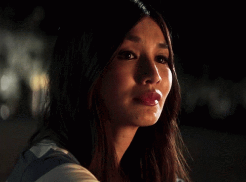 A Close Up Of A Woman 'S Face With Her Mouth Open GIF