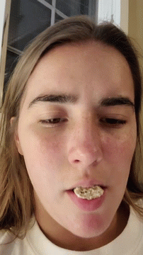 A Close Up Of A Woman 'S Face With Her Mouth Open GIF