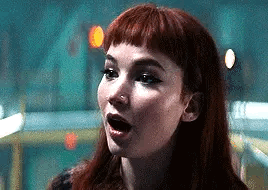 A Close Up Of A Woman 'S Face With Her Mouth Open . GIF