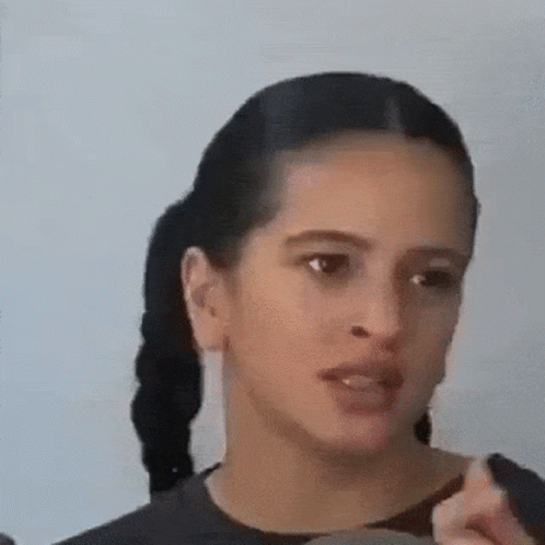 A Close Up Of A Woman 'S Face With Her Mouth Open . GIF