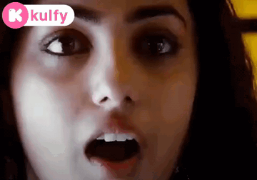 A Close Up Of A Woman 'S Face With Her Mouth Open And A Kolfy Logo In The Corner GIF