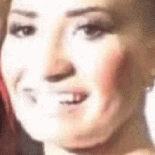 A Close Up Of A Woman 'S Face With Her Mouth Open And A White Background . GIF
