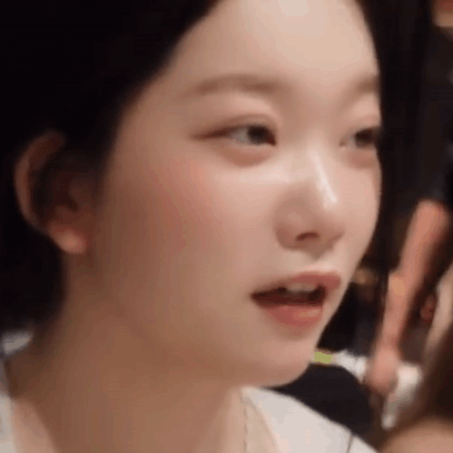 A Close Up Of A Woman 'S Face With Her Mouth Open And Her Eyes Closed . GIF