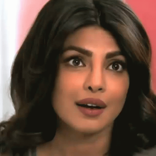 A Close Up Of A Woman 'S Face With Her Mouth Open And Her Eyes Closed . GIF