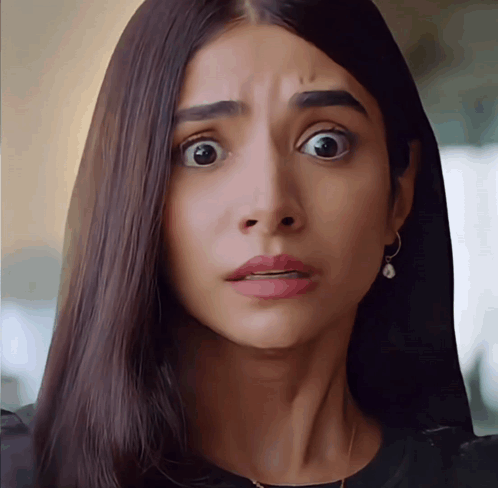 A Close Up Of A Woman 'S Face With Her Mouth Open GIF