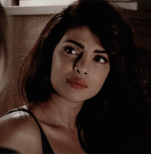 A Close Up Of A Woman 'S Face With Her Mouth Open GIF