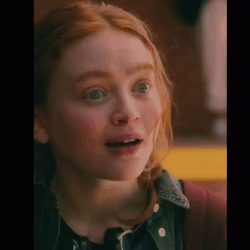 A Close Up Of A Woman 'S Face With Her Mouth Open . GIF