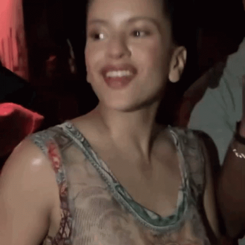 A Close Up Of A Woman 'S Face With Her Mouth Open GIF