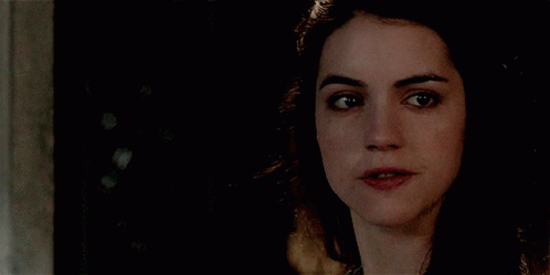 A Close Up Of A Woman 'S Face With Her Mouth Open GIF