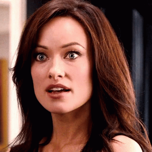 A Close Up Of A Woman 'S Face With Her Mouth Open GIF
