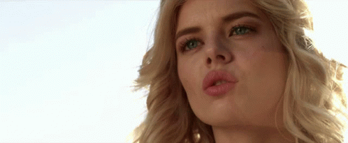 A Close Up Of A Woman 'S Face With Her Mouth Open GIF