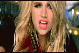 A Close Up Of A Woman 'S Face With Her Mouth Open . GIF
