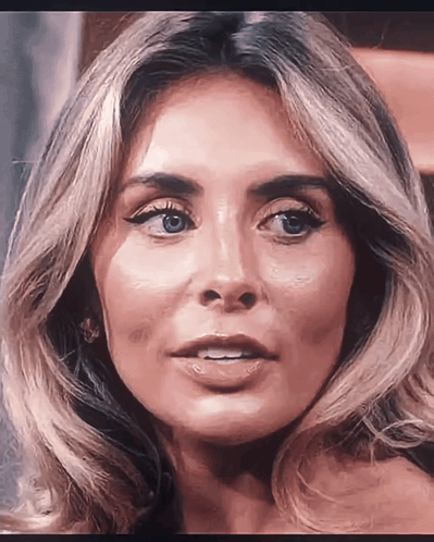 A Close Up Of A Woman 'S Face With Her Mouth Open GIF