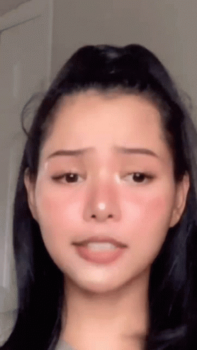 A Close Up Of A Woman 'S Face With Her Mouth Open GIF