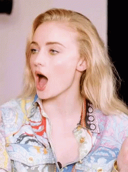 A Close Up Of A Woman 'S Face With Her Mouth Wide Open GIF