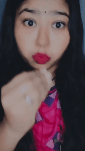 A Close Up Of A Woman 'S Face With Her Tongue Hanging Out GIF
