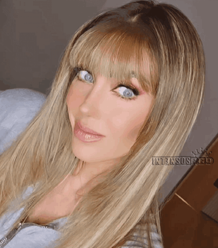A Close Up Of A Woman 'S Face With Intensospeed Written Below Her GIF