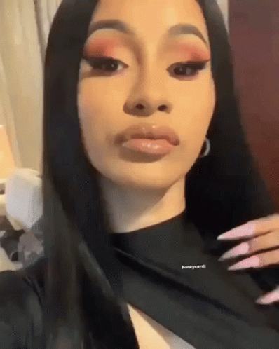 A Close Up Of A Woman 'S Face With Long Black Hair . GIF